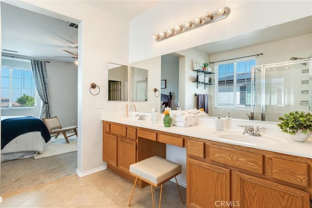 15190 Fox Ridge Dr, Fontana, CA 92336 - ensuite bathroom with double vanity, plenty of natural light, a stall shower, and tile patterned floors