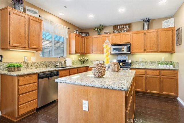 15190 Fox Ridge Dr, Fontana, CA 92336 - kitchen with stainless steel appliances, a sink, dark wood finished floors, light stone countertops, and a center island