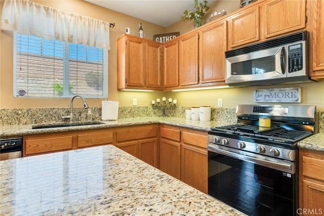 15190 Fox Ridge Dr, Fontana, CA 92336 - kitchen featuring stainless steel appliances, a sink, light stone counters, and wood finished floors