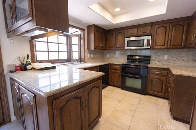 1903 W W Wind, Santa Ana, CA 92704 - kitchen with black appliances, a raised ceiling, decorative backsplash, a sink, and light stone counters