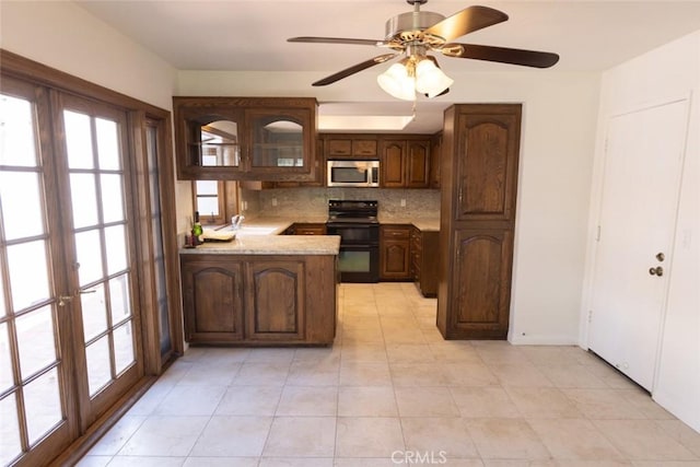 1903 W W Wind, Santa Ana, CA 92704 - kitchen with black / electric stove, stainless steel microwave, a peninsula, backsplash, and a sink