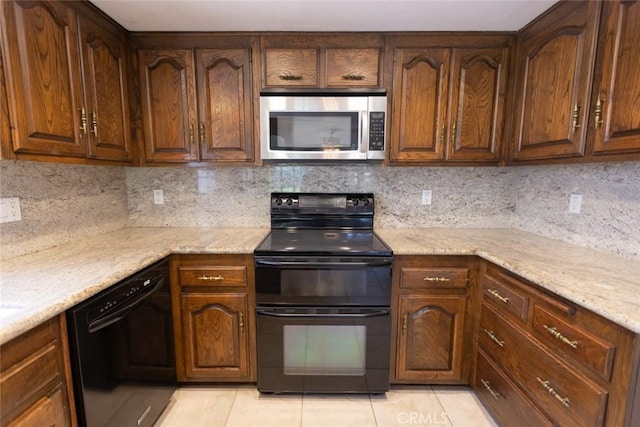 1903 W W Wind, Santa Ana, CA 92704 - kitchen with black appliances, light tile patterned floors, decorative backsplash, and light stone countertops