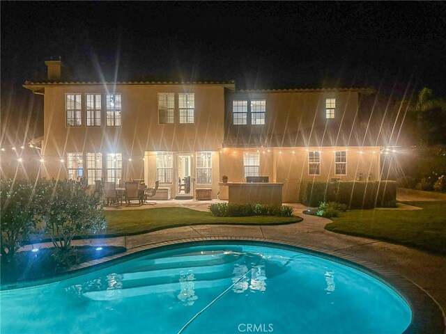 26865 Grey Pl, Stevenson Ranch, CA 91381 - pool at twilight featuring a patio, an outdoor pool, french doors, and a yard
