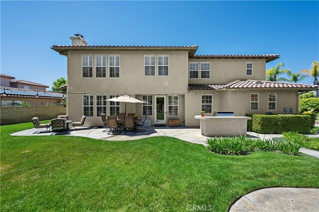 26865 Grey Pl, Stevenson Ranch, CA 91381 - rear view of property with a patio, a chimney, stucco siding, and an outdoor fire pit