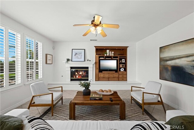 26865 Grey Pl, Stevenson Ranch, CA 91381 - tiled living area featuring a ceiling fan, baseboards, and a glass covered fireplace