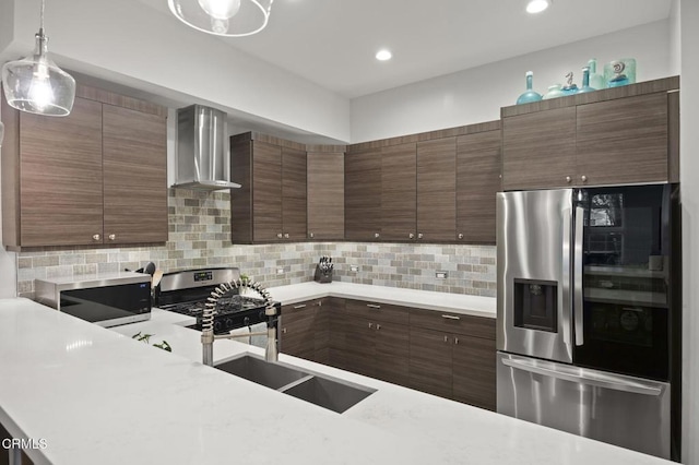 3236 Royal Oaks Dr Unit 5, Thousand Oaks, CA 91362 - kitchen featuring stainless steel appliances, wall chimney exhaust hood, light countertops, backsplash, and pendant lighting
