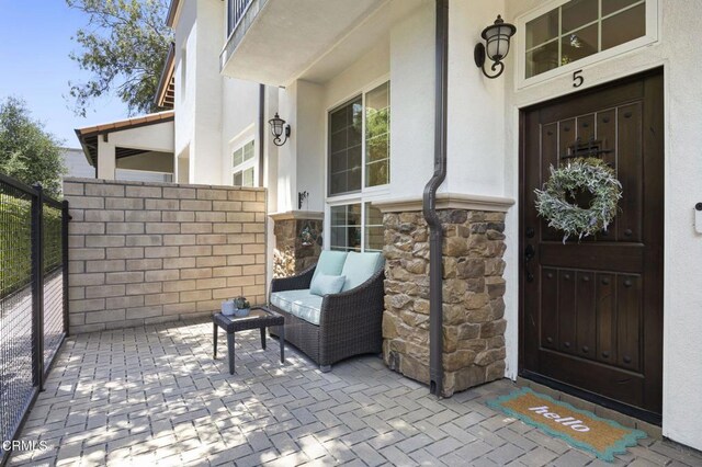 3236 Royal Oaks Dr Unit 5, Thousand Oaks, CA 91362 - view of exterior entry with stucco siding, stone siding, and a patio