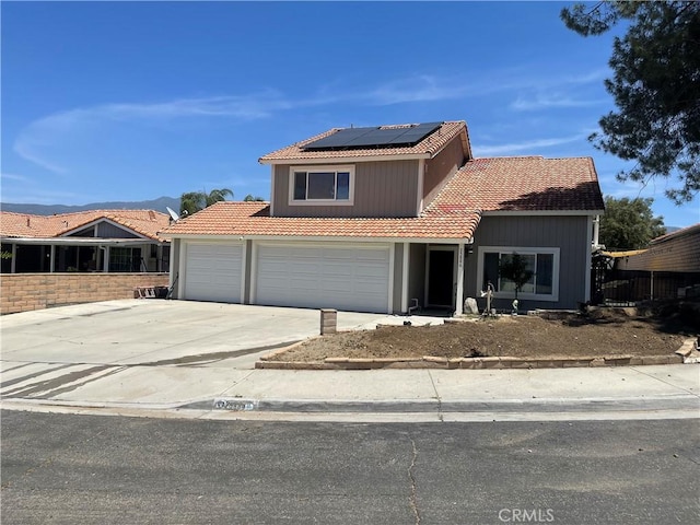 25886 Faircrest Cir, Hemet, CA 92544 - traditional home featuring a tiled roof, driveway, solar panels, and a garage