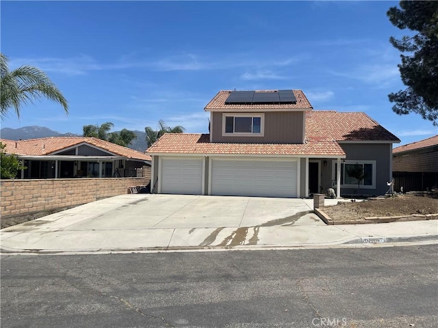 25886 Faircrest Cir, Hemet, CA 92544 - view of front of home with a tiled roof, solar panels, an attached garage, and concrete driveway