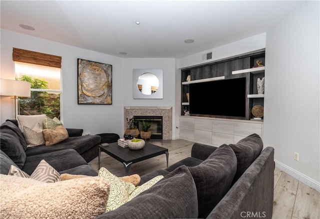 3667 Hawks Dr, Brea, CA 92823 - living room featuring wood finished floors, a fireplace, baseboards, and built in features
