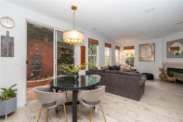 3667 Hawks Dr, Brea, CA 92823 - dining room with light wood-style floors, a glass covered fireplace, and baseboards