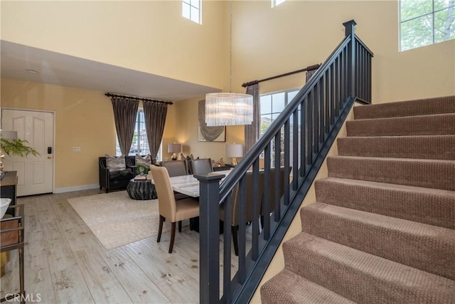 3667 Hawks Dr, Brea, CA 92823 - stairway featuring wood finished floors, a high ceiling, and baseboards