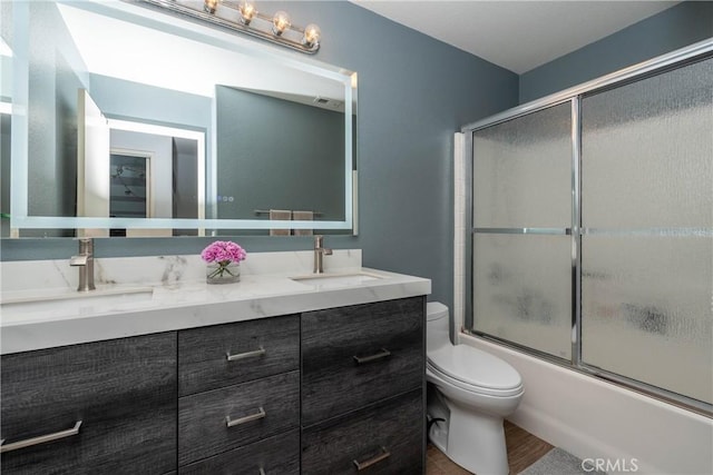 3667 Hawks Dr, Brea, CA 92823 - bathroom featuring double vanity, toilet, shower / bath combination with glass door, and wood finished floors