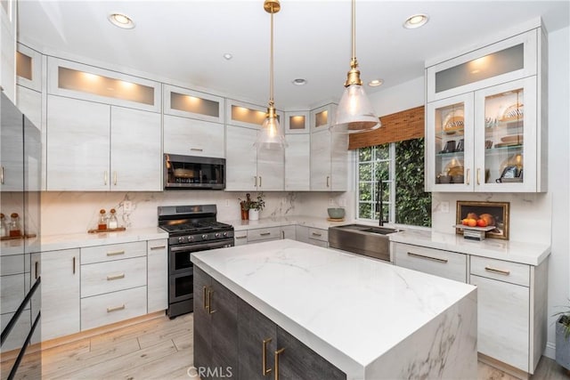 3667 Hawks Dr, Brea, CA 92823 - kitchen with stainless steel appliances, tasteful backsplash, light stone countertops, a kitchen island, and hanging light fixtures