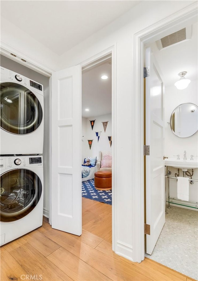 7161/2 Iris Ave, Corona Del Mar, CA 92625 - washroom featuring stacked washer / drying machine and light wood finished floors