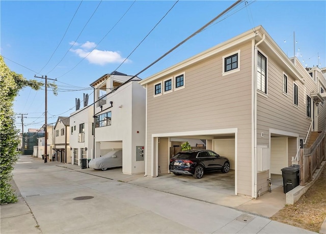 7161/2 Iris Ave, Corona Del Mar, CA 92625 - view of side of home with a garage, concrete driveway, and a residential view