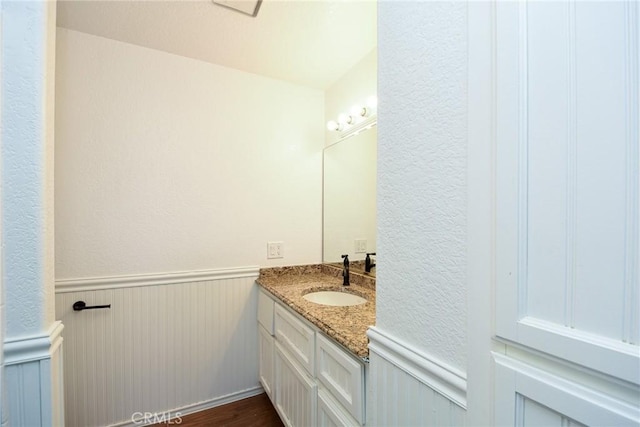 36055 Maddalena Rd, Winchester, CA 92596 - bathroom with vanity, wainscoting, and a textured wall