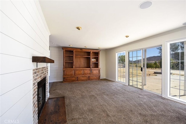 36055 Maddalena Rd, Winchester, CA 92596 - unfurnished living room with crown molding, carpet flooring, healthy amount of natural light, a brick fireplace, and baseboards