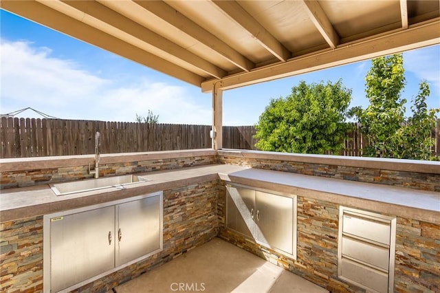 522 Sansoni St, Los Banos, CA 93635 - fenced backyard with a sink, exterior kitchen, and a patio