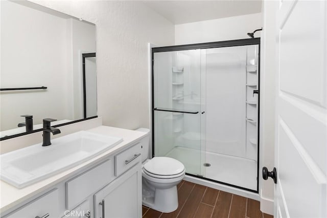 522 Sansoni St, Los Banos, CA 93635 - full bath featuring a stall shower, toilet, wood finished floors, and vanity