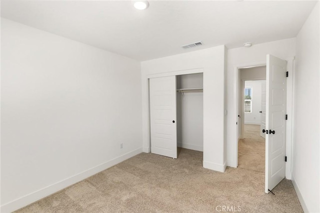 522 Sansoni St, Los Banos, CA 93635 - unfurnished bedroom with light colored carpet, baseboards, and a closet