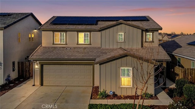 522 Sansoni St, Los Banos, CA 93635 - traditional-style home with board and batten siding, a garage, driveway, and solar panels