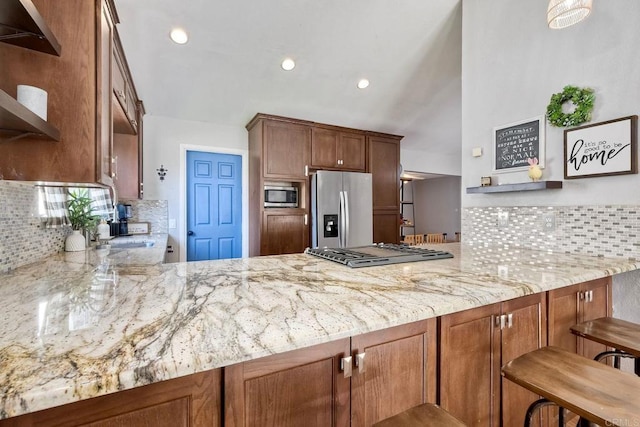 1807 Calle Sinaloa, Vista, CA 92084 - kitchen featuring stainless steel appliances, a peninsula, light stone counters, decorative backsplash, and recessed lighting