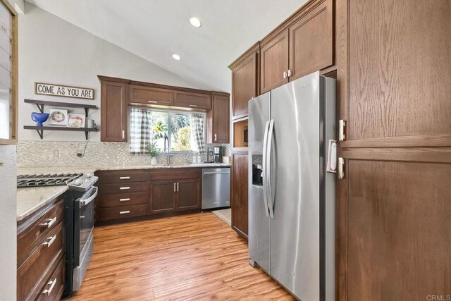 1807 Calle Sinaloa, Vista, CA 92084 - kitchen with stainless steel appliances, lofted ceiling, tasteful backsplash, light wood finished floors, and recessed lighting