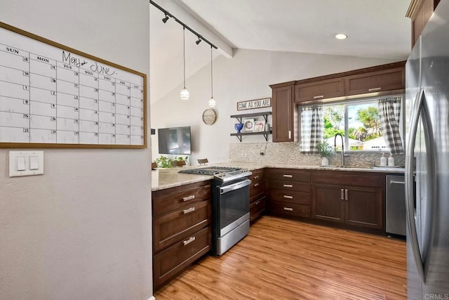 1807 Calle Sinaloa, Vista, CA 92084 - kitchen featuring appliances with stainless steel finishes, a sink, light wood-style floors, light stone counters, and rail lighting