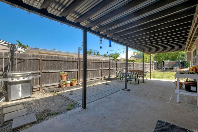 1807 Calle Sinaloa, Vista, CA 92084 - fenced backyard featuring a grill, a patio area, outdoor dining area, and a trampoline