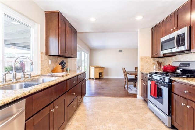 2065 Medina Ave, Simi Valley, CA 93063 - kitchen featuring stainless steel appliances, a sink, baseboards, recessed lighting, and light stone counters