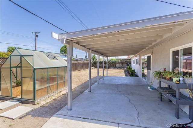 2065 Medina Ave, Simi Valley, CA 93063 - fenced backyard with a greenhouse, a patio area, and an outbuilding