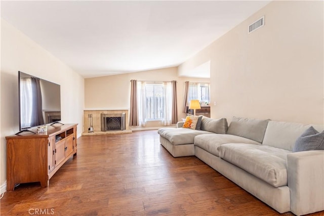 2065 Medina Ave, Simi Valley, CA 93063 - living area with wood finished floors, vaulted ceiling, a fireplace with raised hearth, and baseboards