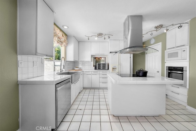 377 Roycroft Ave, Long Beach, CA 90814 - kitchen with stainless steel appliances, tile counters, island range hood, a center island, and backsplash