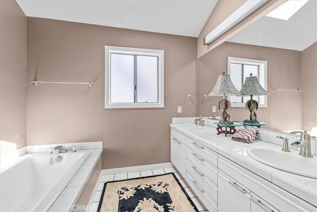 377 Roycroft Ave, Long Beach, CA 90814 - bathroom featuring double vanity, a bath, baseboards, and a skylight