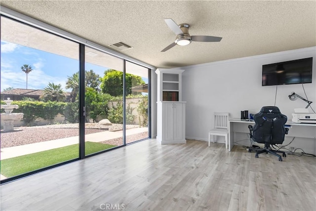 171 Yale Dr, Rancho Mirage, CA 92270 - office area featuring a textured ceiling, a wall of windows, a ceiling fan, and wood finished floors