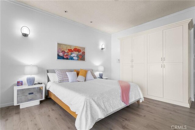 171 Yale Dr, Rancho Mirage, CA 92270 - bedroom featuring ornamental molding, wood finished floors, and a closet