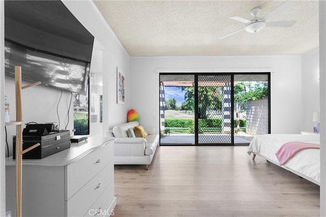 171 Yale Dr, Rancho Mirage, CA 92270 - bedroom featuring access to exterior, a textured ceiling, light wood-type flooring, and a ceiling fan