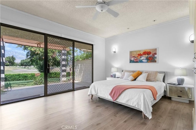 171 Yale Dr, Rancho Mirage, CA 92270 - bedroom featuring multiple windows, a textured ceiling, crown molding, access to outside, and wood finished floors