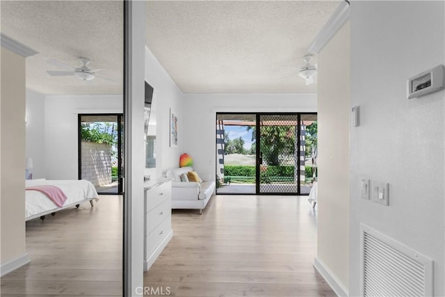 171 Yale Dr, Rancho Mirage, CA 92270 - hallway with light wood-type flooring, a textured ceiling, ornamental molding, and baseboards