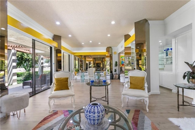 171 Yale Dr, Rancho Mirage, CA 92270 - living area with crown molding, light wood-type flooring, a textured ceiling, and recessed lighting