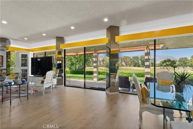 171 Yale Dr, Rancho Mirage, CA 92270 - dining area featuring a textured ceiling, ornamental molding, wood finished floors, recessed lighting, and plenty of natural light