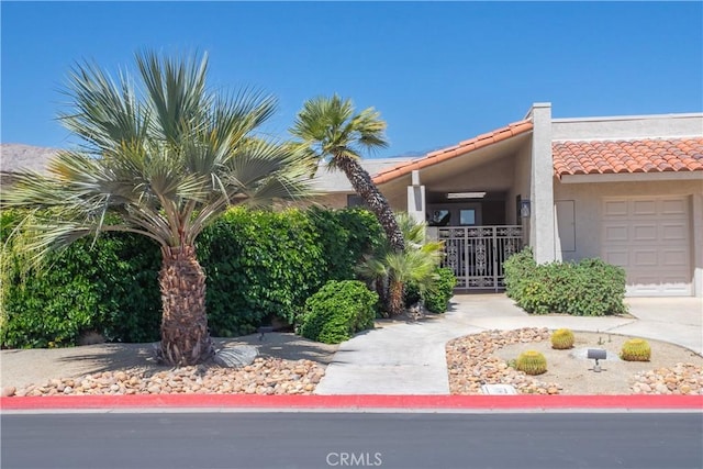 171 Yale Dr, Rancho Mirage, CA 92270 - view of front facade with a tiled roof, a garage, stucco siding, and concrete driveway