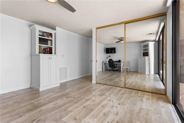 171 Yale Dr, Rancho Mirage, CA 92270 - unfurnished living room with ceiling fan, an office area, light wood finished floors, a textured ceiling, and crown molding