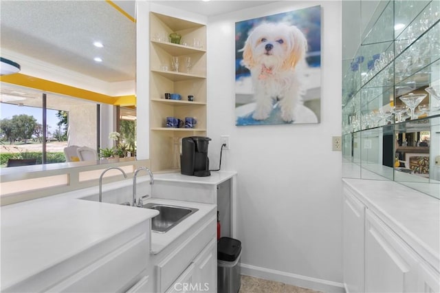 171 Yale Dr, Rancho Mirage, CA 92270 - kitchen with white cabinetry, light countertops, a sink, recessed lighting, and crown molding