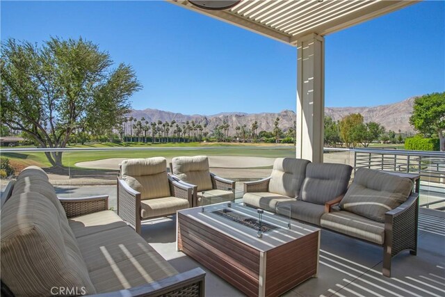 171 Yale Dr, Rancho Mirage, CA 92270 - view of patio with a mountain view, an outdoor living space with a fire pit, and view of golf course