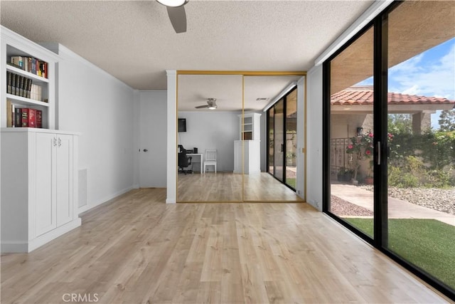 171 Yale Dr, Rancho Mirage, CA 92270 - unfurnished room featuring ceiling fan, wood finished floors, floor to ceiling windows, and a textured ceiling