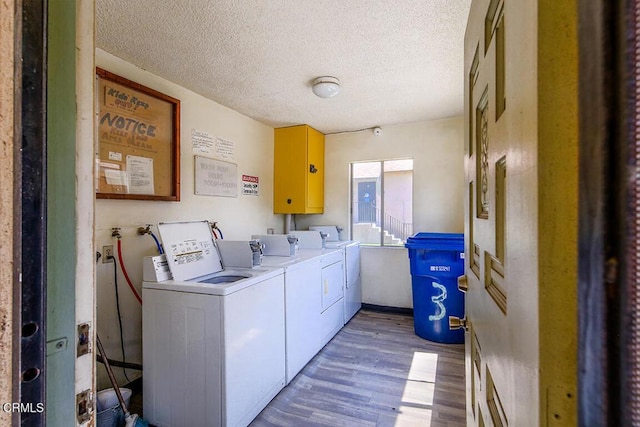 12528 Bradley Ave, Los Angeles, CA 91342 - communal laundry room with wood finished floors, independent washer and dryer, and a textured ceiling