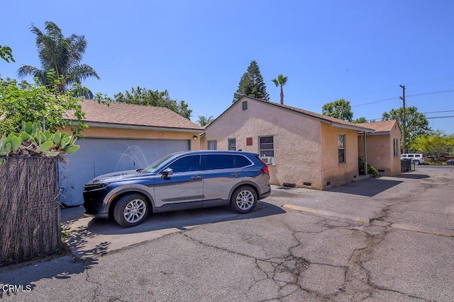 12528 Bradley Ave, Los Angeles, CA 91342 - view of side of property with crawl space, stucco siding, and driveway