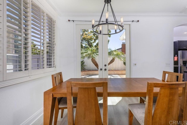 8375 Gold Coast Dr Unit 4, San Diego, CA 92126 - dining area with a chandelier, crown molding, arched walkways, wood finished floors, and baseboards